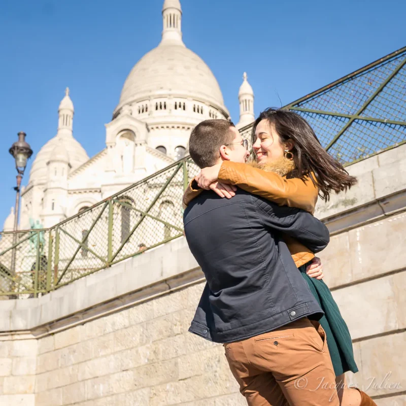 happy young man hugging his girlfriend at Montmartre